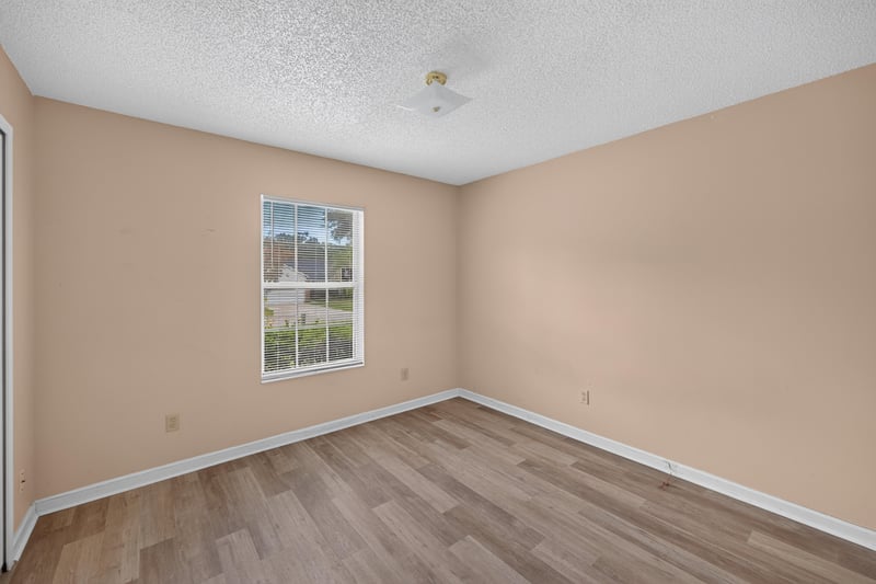 Bedroom with window and wood-look floors at 6646 Shiloh Creek Dr