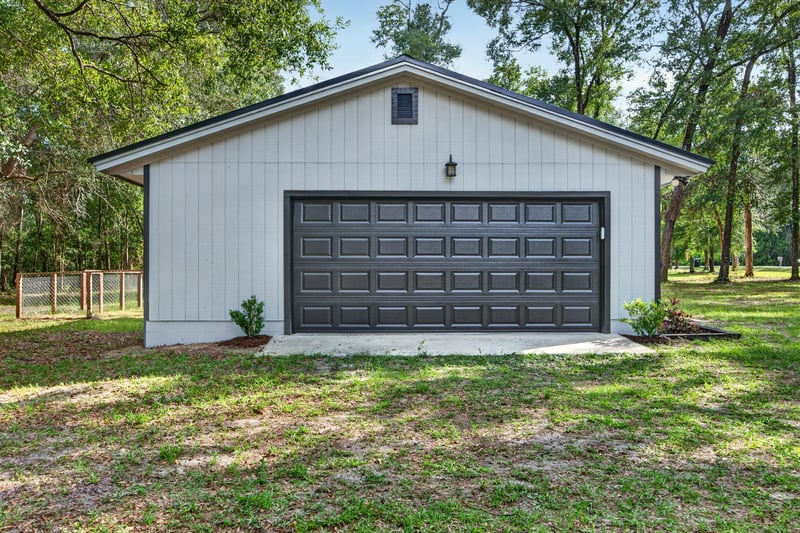 Detached garage exterior with black door at 2829 Blackberry Ave