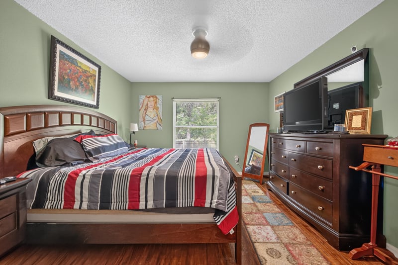 Bedroom with wood bed frame and window at 145 Dover Bluff Dr, Orange Park, FL
