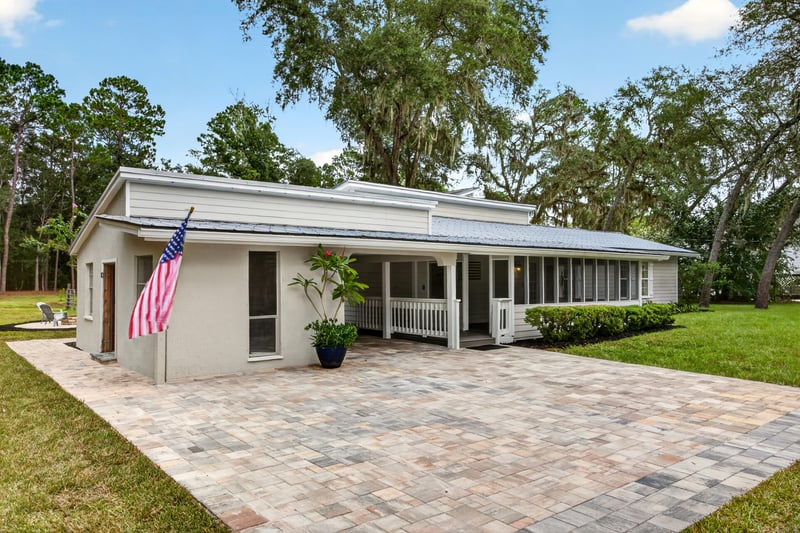 Front entry with brick paver walkway and flag at 1161 Whispering Pines Rd, Jacksonville, FL 32259