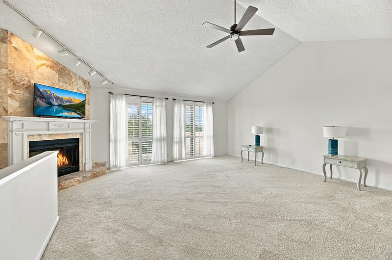 Empty room with fireplace, ceiling fan and carpet at 752 Spinnakers Reach Dr, Ponte Vedra Beach, FL 32082