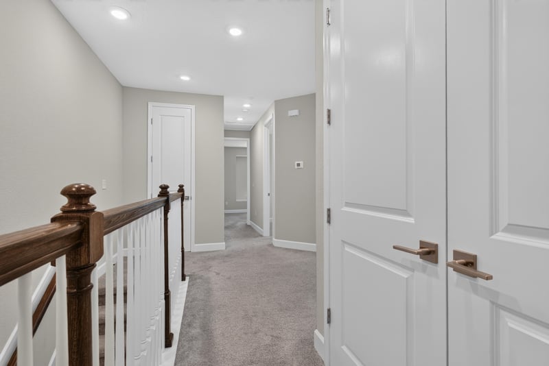 Upstairs hallway with closet doors at 7446 Loggerhead Ct, Jacksonville, FL 32256