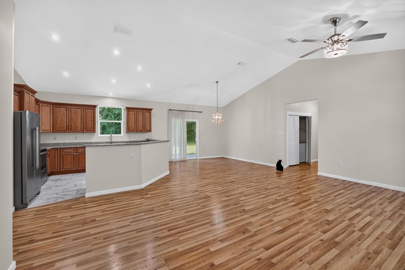 Open kitchen and living room with vaulted ceiling at 1012 Fruit Cove Rd, Jacksonville, FL 32259
