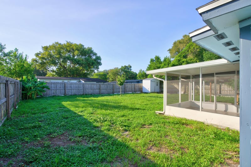 Fenced backyard with screened porch at 442 Ameca Ave, Orange Park, FL 32073