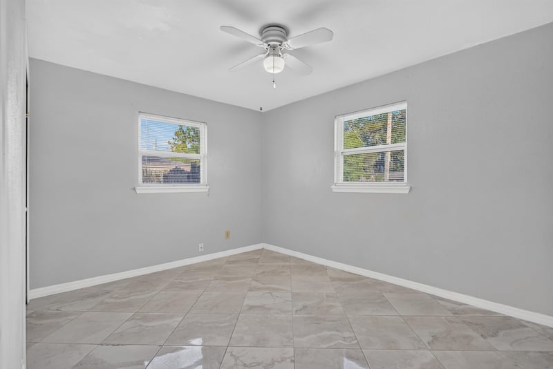 Bedroom with tile flooring and two windows at 442 Ameca Ave, Orange Park, FL 32073