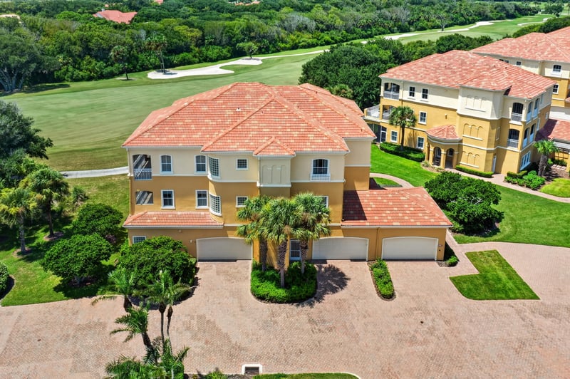 Aerial of tile-roof home with brick paver driveway at 140 Ave De La Mer, Palm Coast, FL 32137