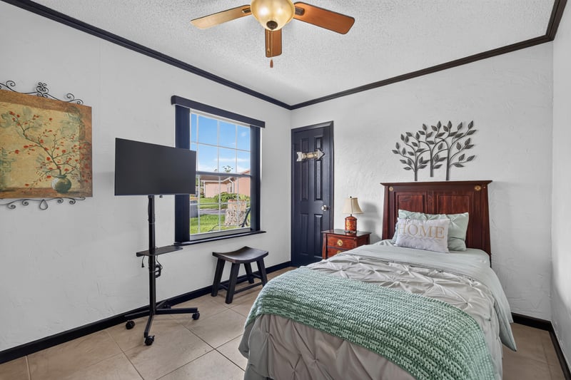 Bedroom with map art and music stand at 6931 Cane Grass Ln E, Jacksonville, FL 32244
