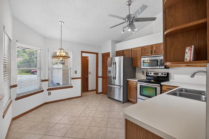 Kitchen counter and pass-through with stainless appliances at 2460 San Sago Ln, Jacksonville, FL
