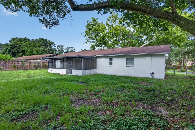 Rear exterior with carport and screened porch at 12351 Condor Dr