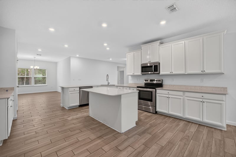 Kitchen with white cabinets and island at 9905 Ansley Lake Dr, Jacksonville, FL