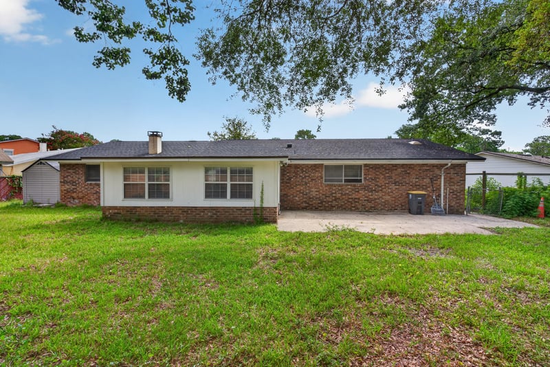 Backyard view with mature trees at 9954 Larkdale Ct, Jacksonville, FL 32257