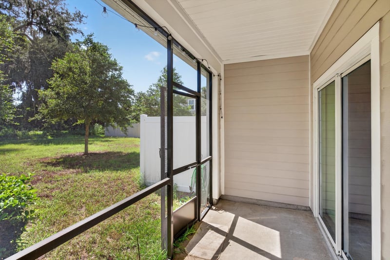 Screened porch view of backyard at 1186 Beach Dune Dr, Jacksonville, FL 32233
