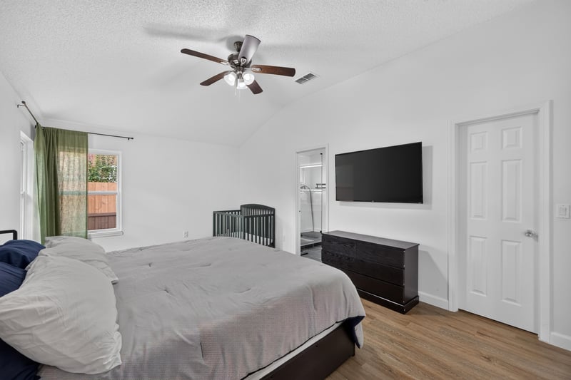 Bedroom with bed and mounted TV at 8921 Needlepoint Pl, Jacksonville, FL 32244