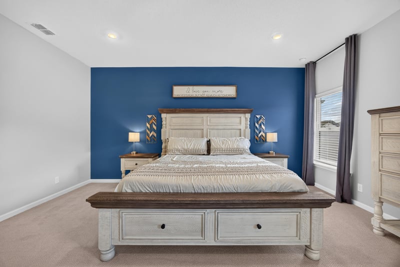 Primary bedroom with wood bed frame and window light at 2354 Jennings Farm Dr, Middleburg, FL 32068