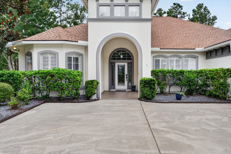 Arched front entry with glass door and shutters at 4109 Eagle Landing Pkwy, Orange Park, FL 32065