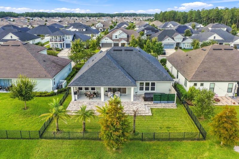 Aerial view of the backyard patio and neighboring pond at 3921 Spyglass Hill Ln