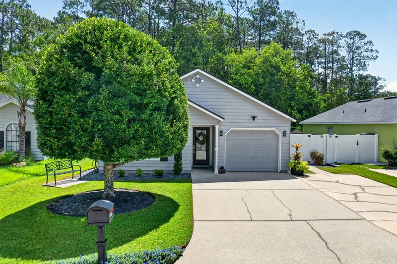 Front exterior with landscaped yard and driveway at 3067 Wavering Ln, Middleburg, FL 32068