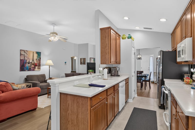 Kitchen island with sink and bar seating at 11225 Water Spring Cir, Jacksonville, FL 32256
