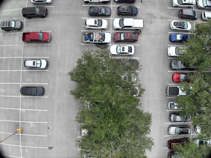 Aerial view of parking lot rows and tree island at 9406 Atlantic Blvd, Jacksonville, FL 32225