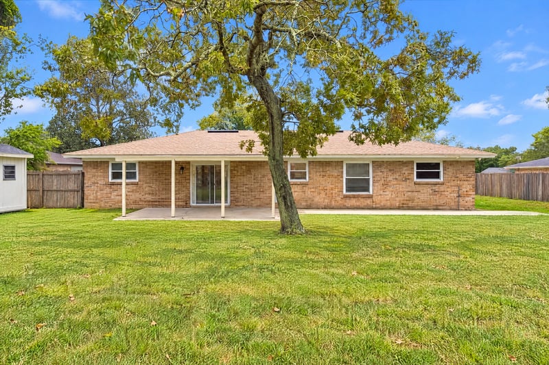 Rear exterior with covered porch and open lawn at 357 Dillon Dr, Orange Park, FL