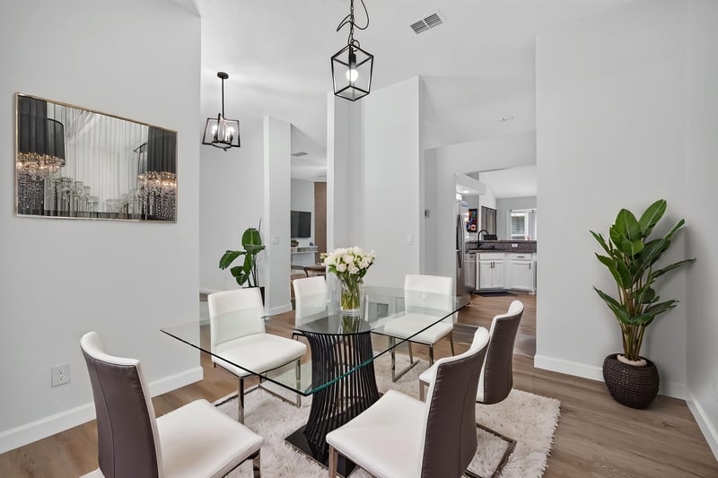Dining area with glass table and pendant light at 8921 Needlepoint Pl, Jacksonville, FL 32244