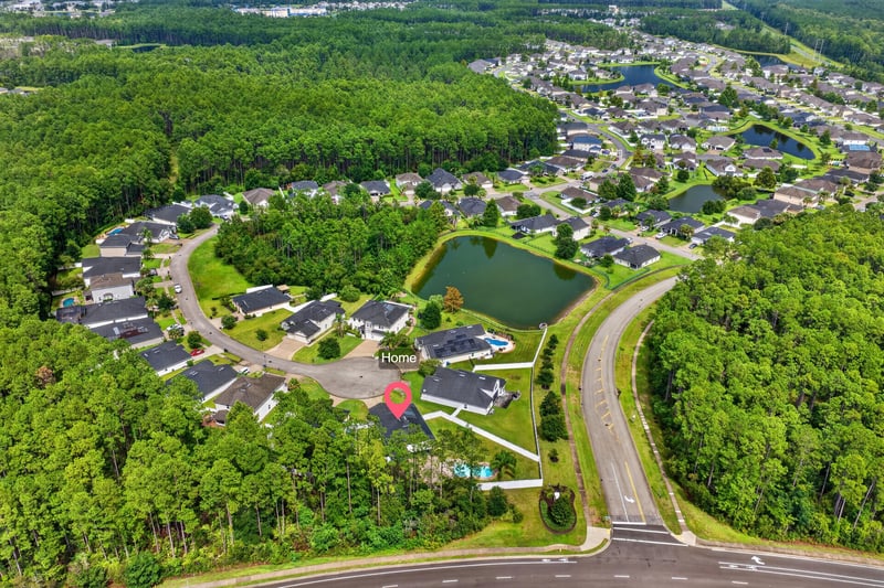 Aerial view of neighborhood streets and pond in St. Johns, FL