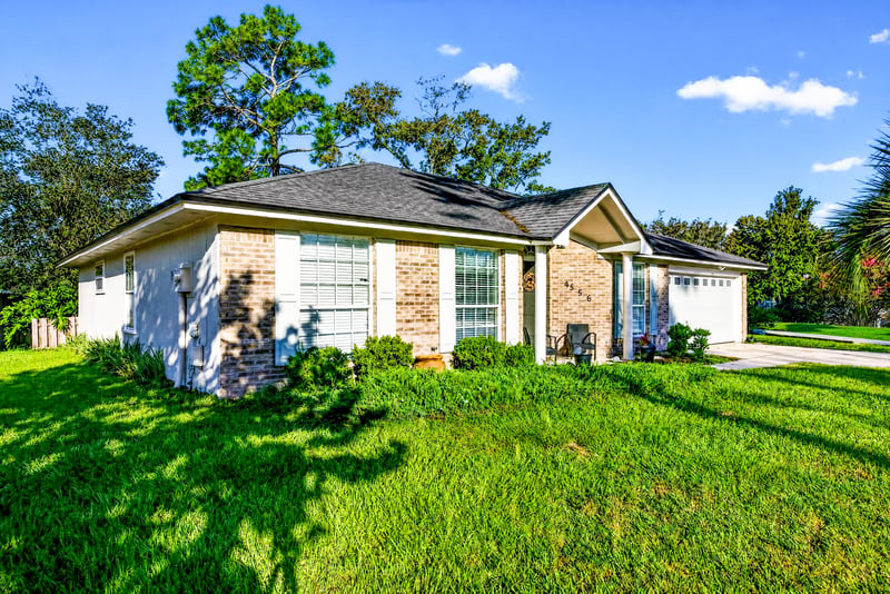 Brick ranch front exterior with landscaping at 4556 Shaky Leaf Ln N, Jacksonville, FL 32224