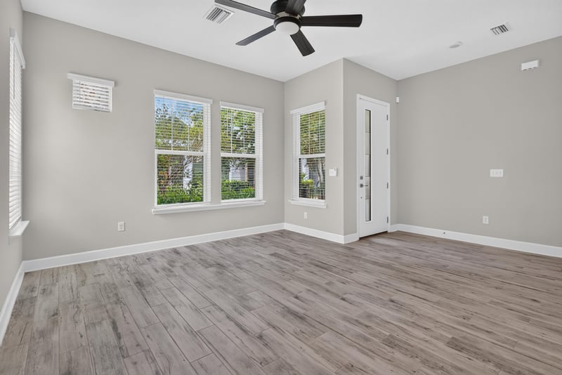 Living room with windows and wood-look floors at 7446 Loggerhead Ct, Jacksonville, FL 32256