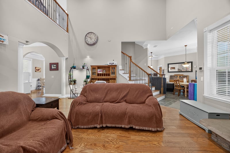 Great room with covered furniture and arched entries at 1735 Hagans Ridge Ct