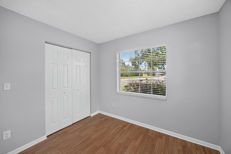 Bedroom with closet door and window at 328 Palos Ct, St. Augustine, FL