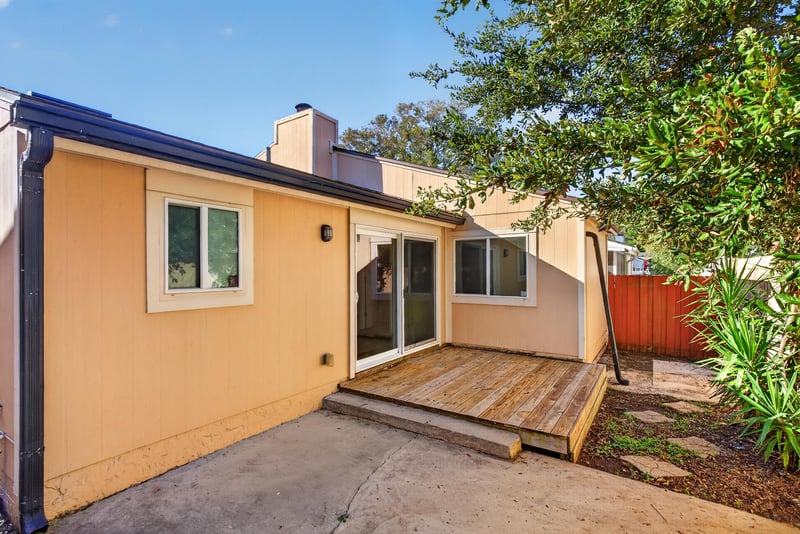 Rear exterior with deck, patio and fenced yard at 8177 Virgo St, Jacksonville, FL 32216