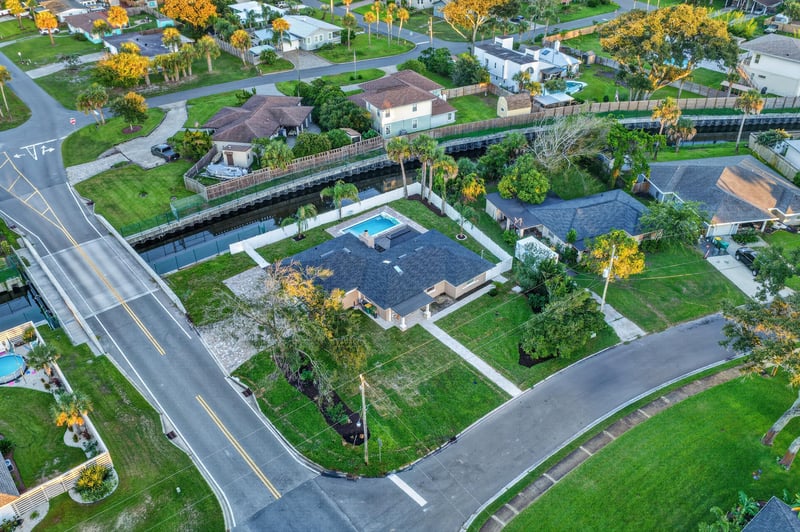 Aerial view of the canal-front street and homes in Jacksonville Beach, FL