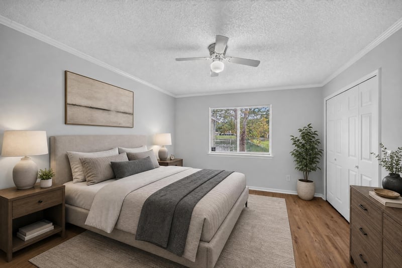 Virtually staged bedroom with bed and wood floors at 8047 Mactavish Way E, Jacksonville, FL 32244