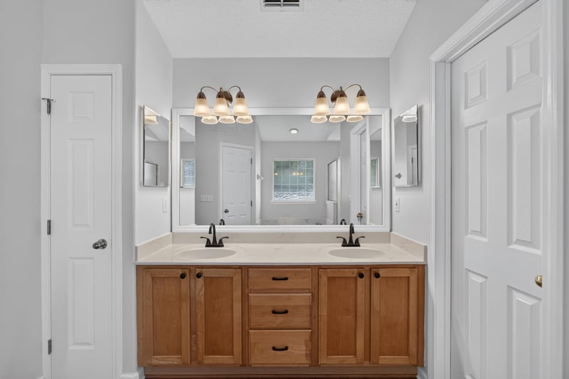 Bathroom with double-sink vanity and mirror at 2480 Ridge Will Dr, Jacksonville, FL 32246