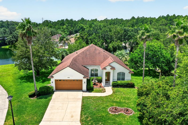 Aerial view of the tile-roofed home and front yard at 2480 Ridge Will Dr, Jacksonville, FL 32246