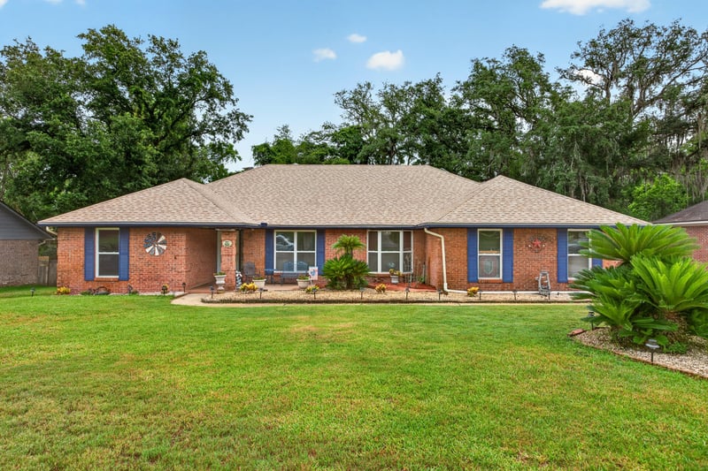 Front exterior of brick ranch home with mature trees at 981 Marble Ridge Dr, Orange Park, FL 32065