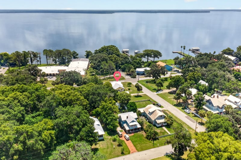Drone view of lake and neighborhood in Crescent City, FL