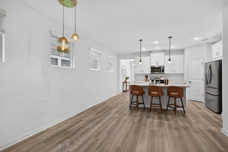 Living room with sectional sofa and pendant lighting at 93 Lochloosa Ct, St. Johns, FL 32259