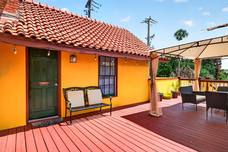 Private deck with seating and a red tile roof view at 115 Cordova St, St. Augustine, FL