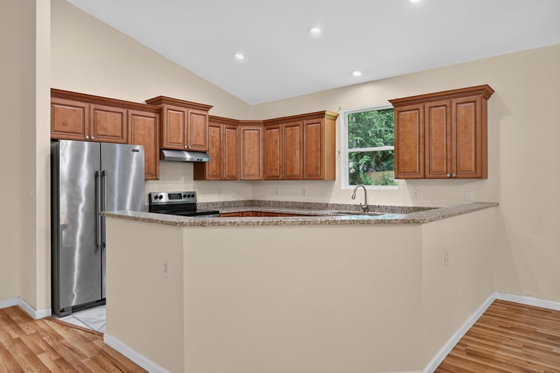 Kitchen with wood cabinets and stainless appliances at 1012 Fruit Cove Rd, Jacksonville, FL 32259