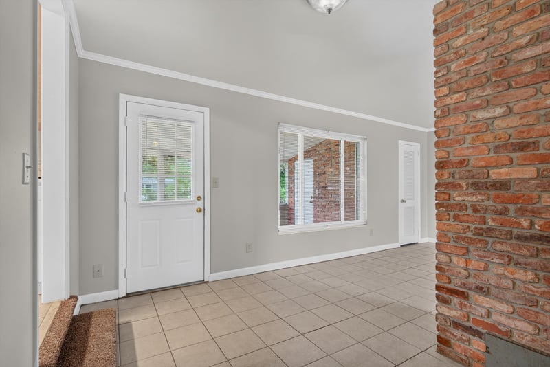 Door to exterior beside brick wall at 2618 Arlex Dr E, Jacksonville, FL