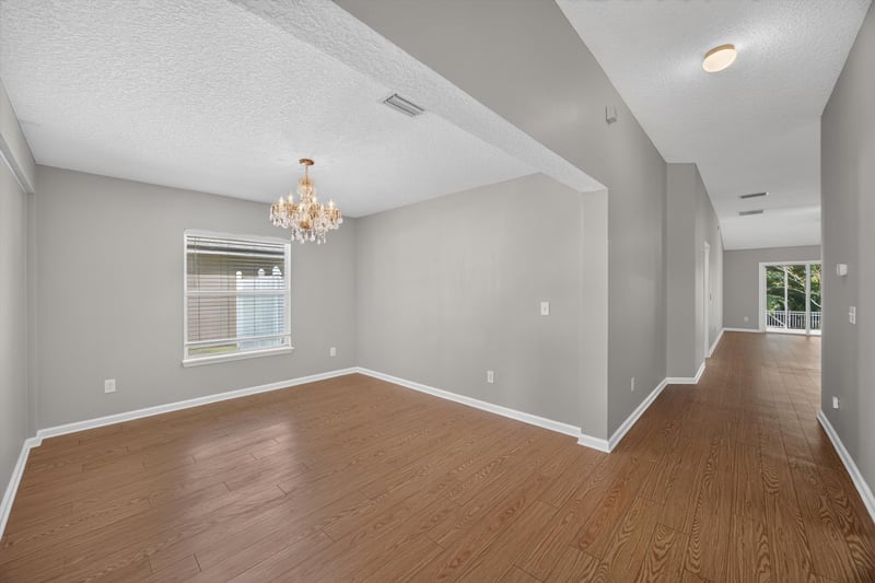 Living room with ceiling fan and chandelier in view at 14147 Fish Eagle Dr E, Jacksonville, FL 32226