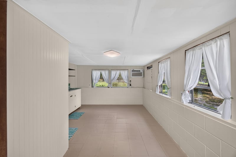 Interior of outbuilding with bare room and windows at 101 N Lake St, Crescent City, FL