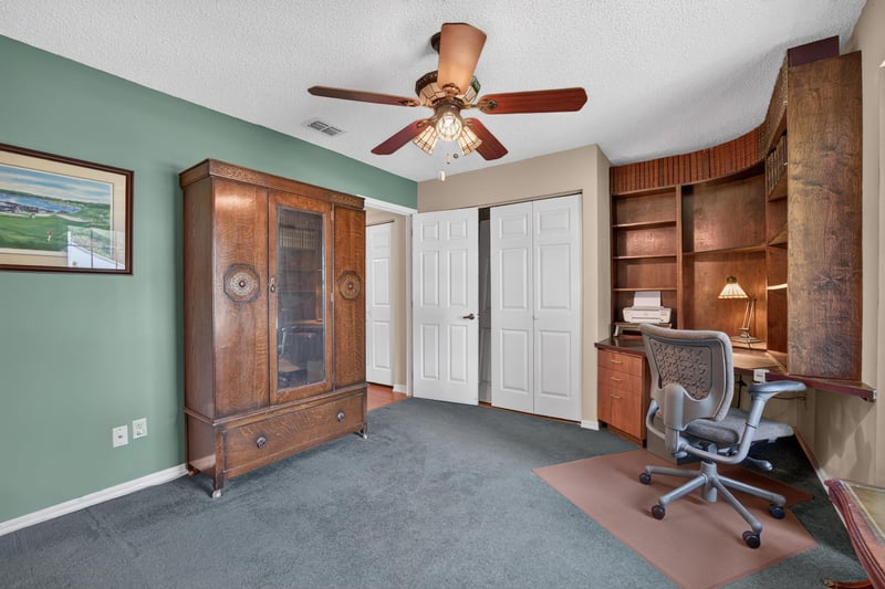 Home office with green walls and armoire at 4837 Pareja Ct, Jacksonville, FL 32225