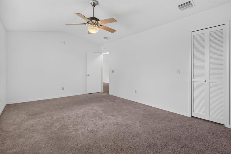 Bedroom with closet doors at 1445 Classic Oak Rd W, Jacksonville, FL