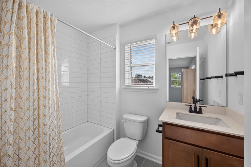 Bathroom with patterned shower curtain and vanity at 2354 Jennings Farm Dr, Middleburg, FL 32068