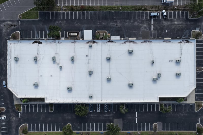 Aerial close-up of a building roof with parking lot below at 10550 Deerwood Park Blvd, Jacksonville, FL 32256