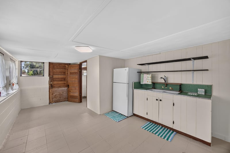 Outbuilding kitchenette with sink and cabinets at 101 N Lake St, Crescent City, FL