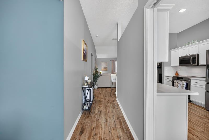 Entry hallway with wood floors leading to kitchen at 12825 Kelsey Island Dr, Jacksonville, FL 32224