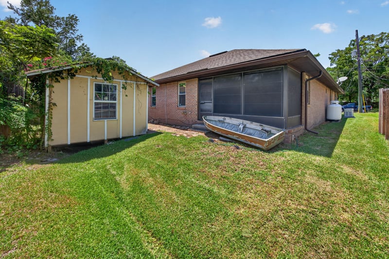 Backyard with screened pool area and storage shed at 2460 San Sago Ln, Jacksonville, FL
